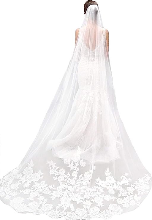 A long, white veil with a lace trim. The veil is draped over a woman's head and shoulders.