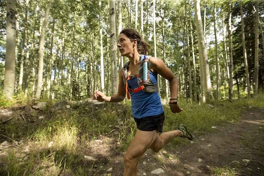 A women is running in the forest with Best Outdoor Gear